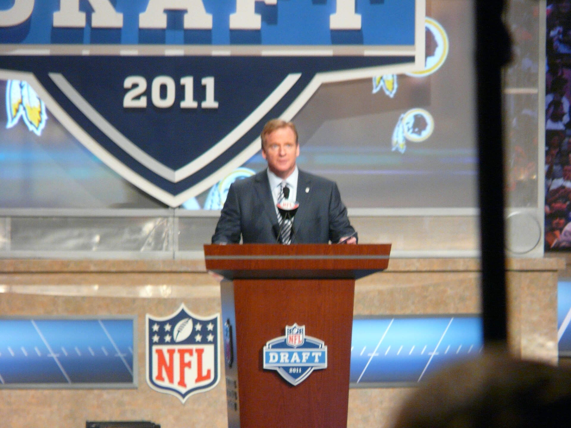 NFL Commissioner Roger Goodell speaking at a podium