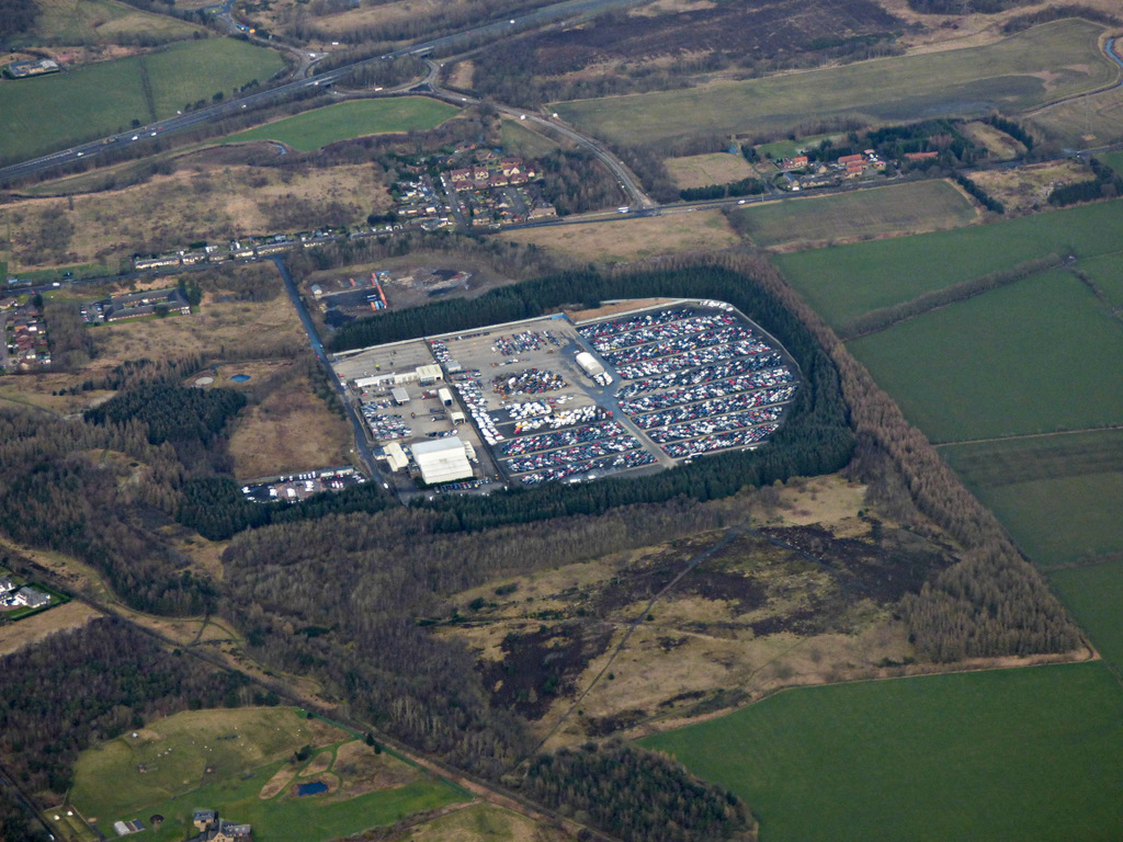 Aerial view of a Copart vehicle auction depot with rows of parked cars