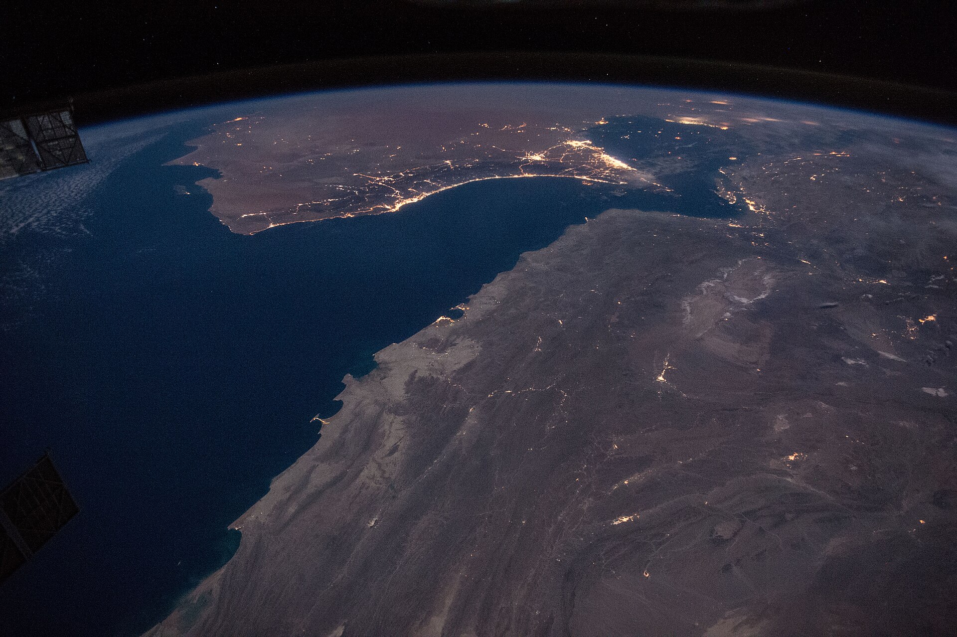 Night-time photograph from the International Space Station showing the Gulf of Oman and the Strait of Hormuz.